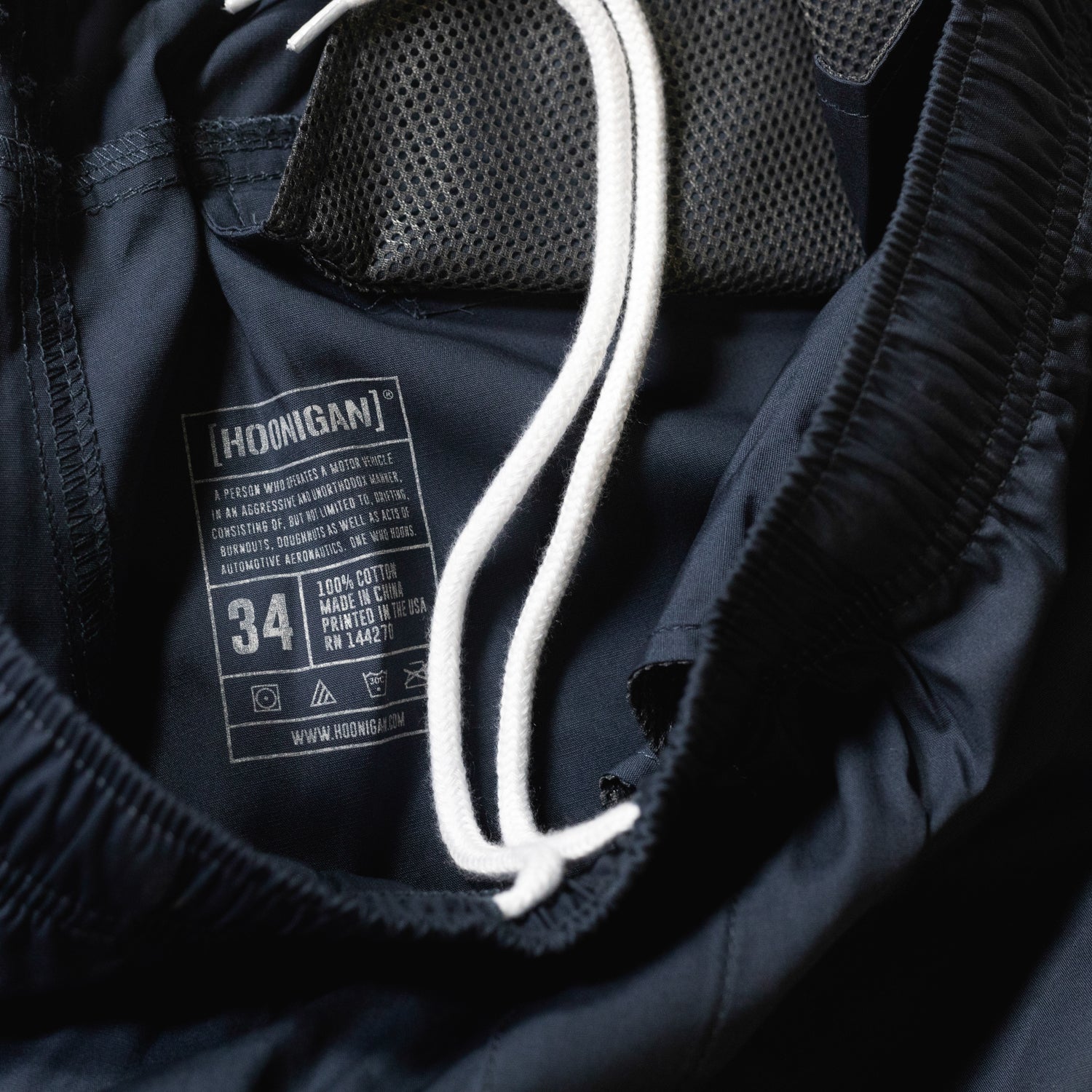 Hoonigan TRACK TEAM athletic shorts in black, featuring a bold white logo and a relaxed fit, designed for active wear.