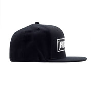 Black snapback hat featuring a bold white Hoonigan logo on the front, perfect for motorsport enthusiasts.