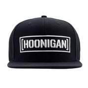 Black snapback hat featuring a bold white embroidered "[HOONIGAN]" logo on the front, perfect for motorsport enthusiasts.