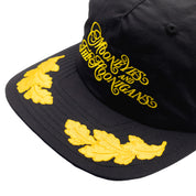 Hoonigan x Mooneyes decorated unstructured snapback hat featuring a black base and colorful embroidered logo on the front.