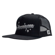Black trucker hat with "The Hoonigans" embroidered in white, mesh back, and adjustable snapback closure.