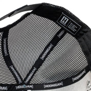 Close-up of the inside of a Hoonigan FIND OUT V2 snapback trucker hat, showing mesh lining, branded tape, and label details.