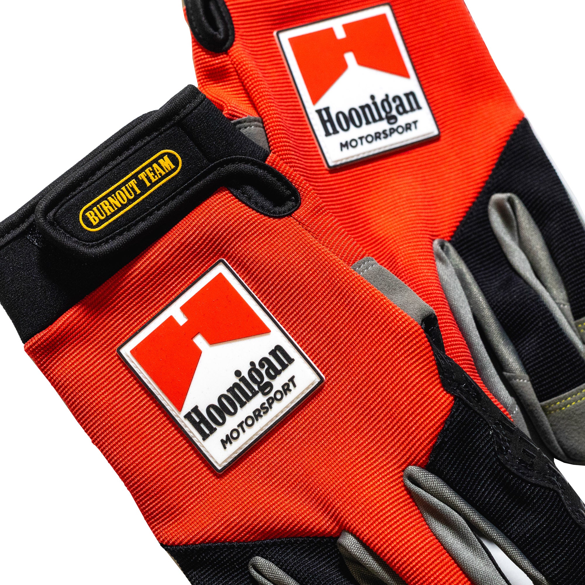 Hoonigan SURGEON GENERAL gloves featuring a black and white design with logo detailing, ideal for motorsports and automotive enthusiasts.