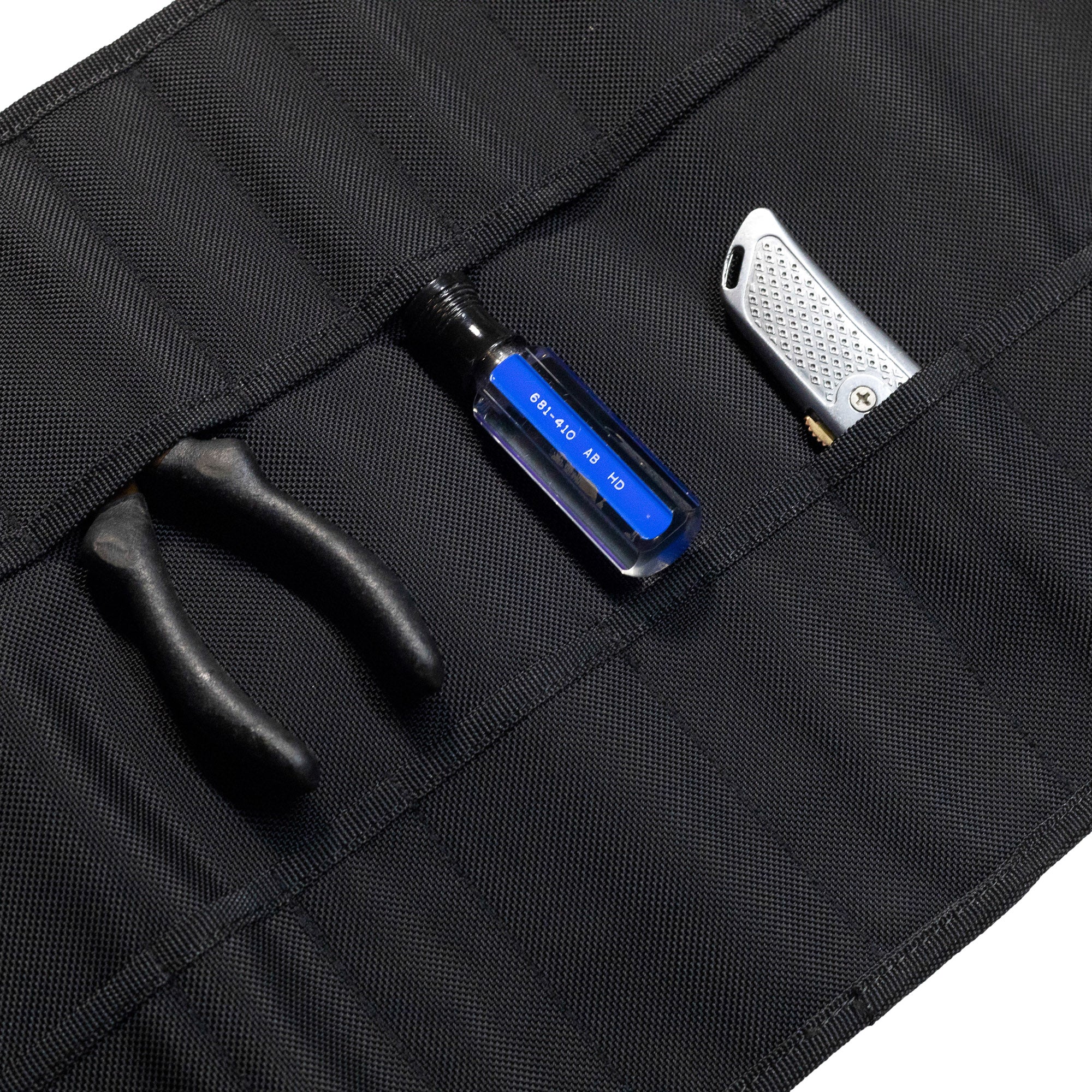 Hoonigan LIL TOOL ROLL featuring compartments for tools, including pliers and a utility knife.