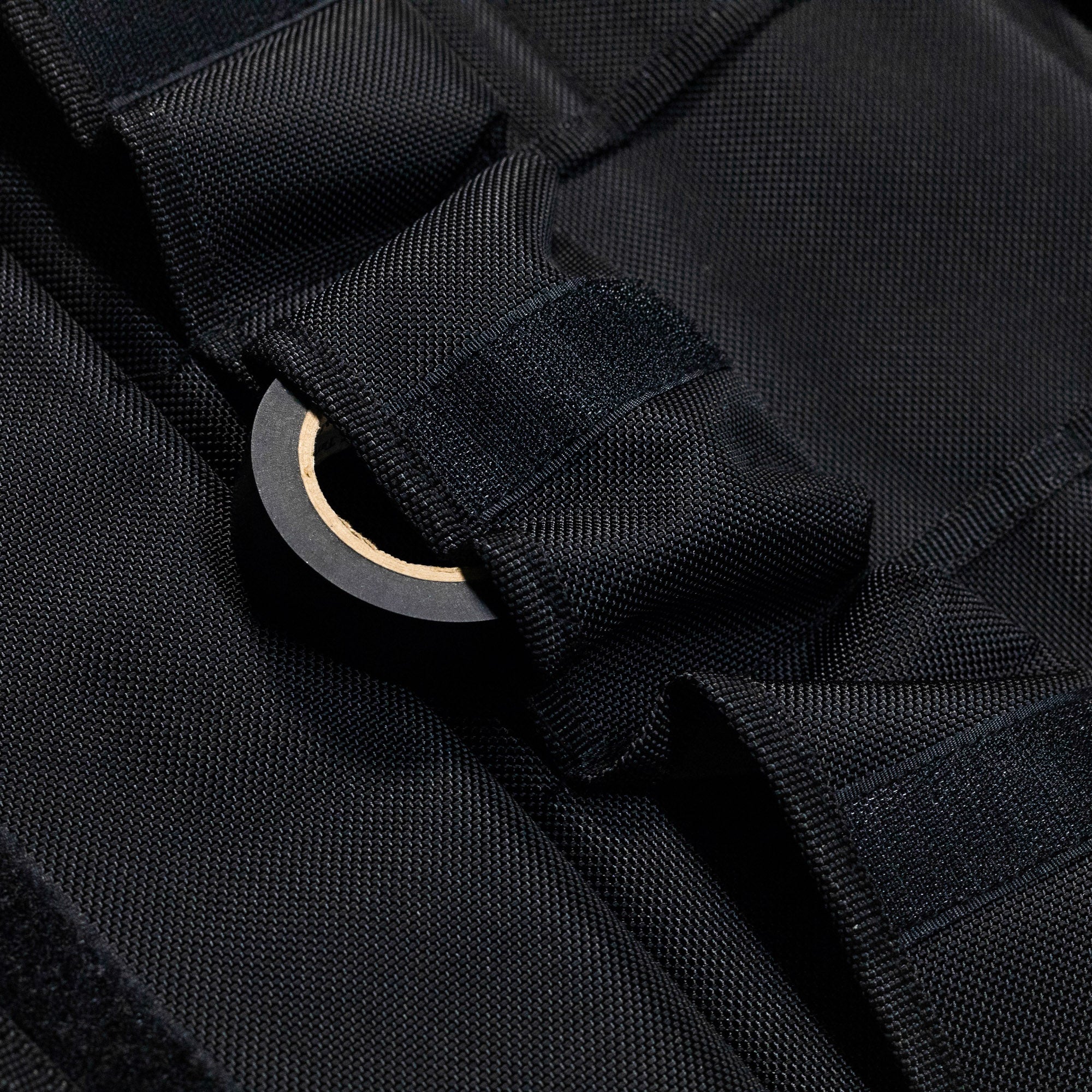 Close-up of the Hoonigan LIL TOOL ROLL showcasing durable black fabric and a secure fastening system for tools.