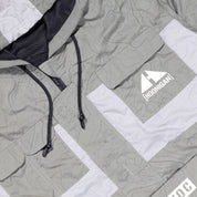 Hoonigan H.A.V.O.C. rain-activated windbreaker jacket with a gray color, black drawstrings, and a white logo patch on the front.
