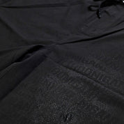 Hoonigan OIL SLICK Board Shorts featuring a sleek black design with a glossy logo print for a stylish look.