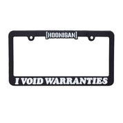 Black license plate frame featuring the text "I VOID WARRANTIES" and the Hoonigan logo, perfect for car enthusiasts.