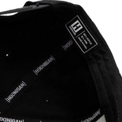 Black Fuel LOGO Snapback Hat interior showing fabric details and Hoonigan branding for automotive enthusiasts.