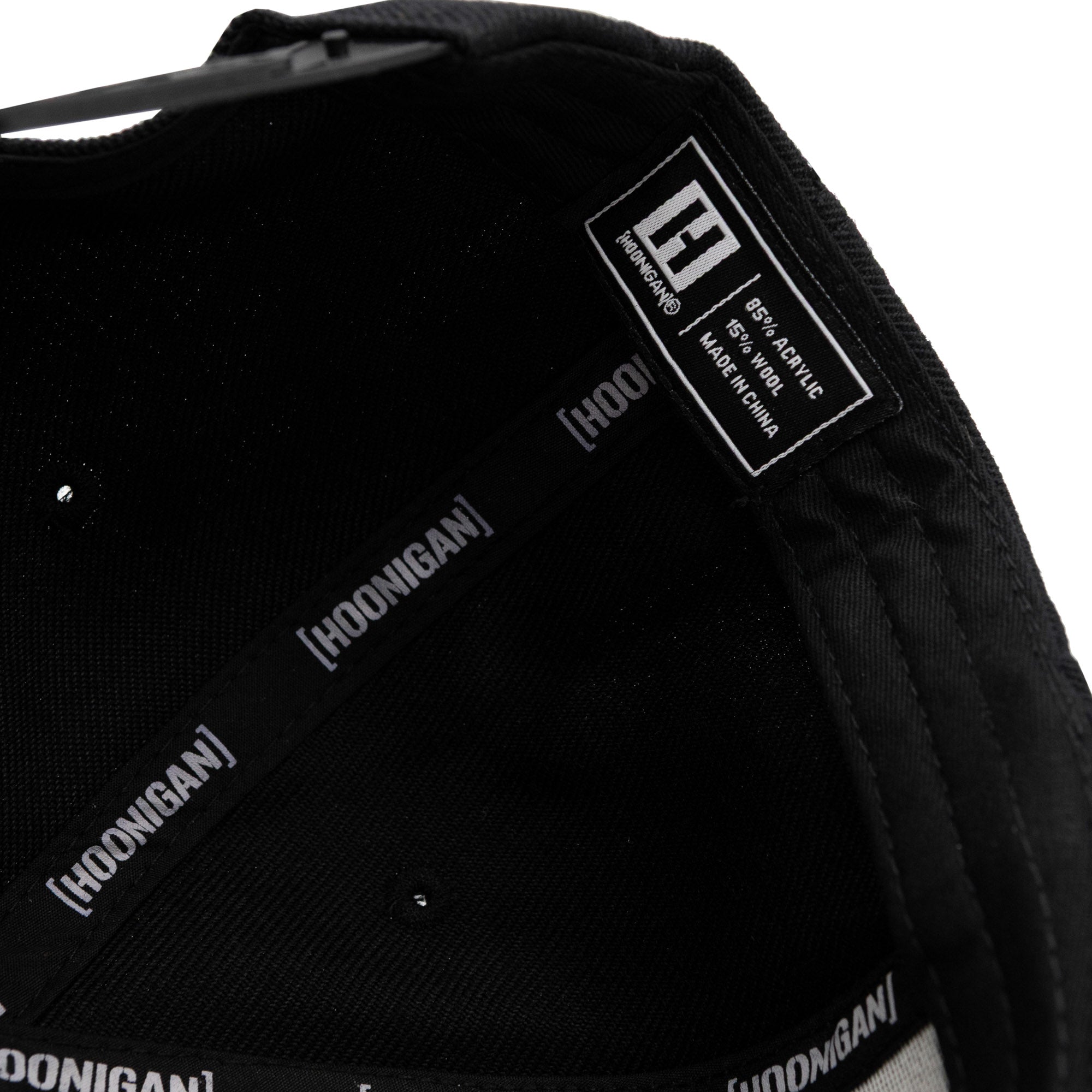 Black Fuel LOGO Snapback Hat interior showing fabric details and Hoonigan branding for automotive enthusiasts.
