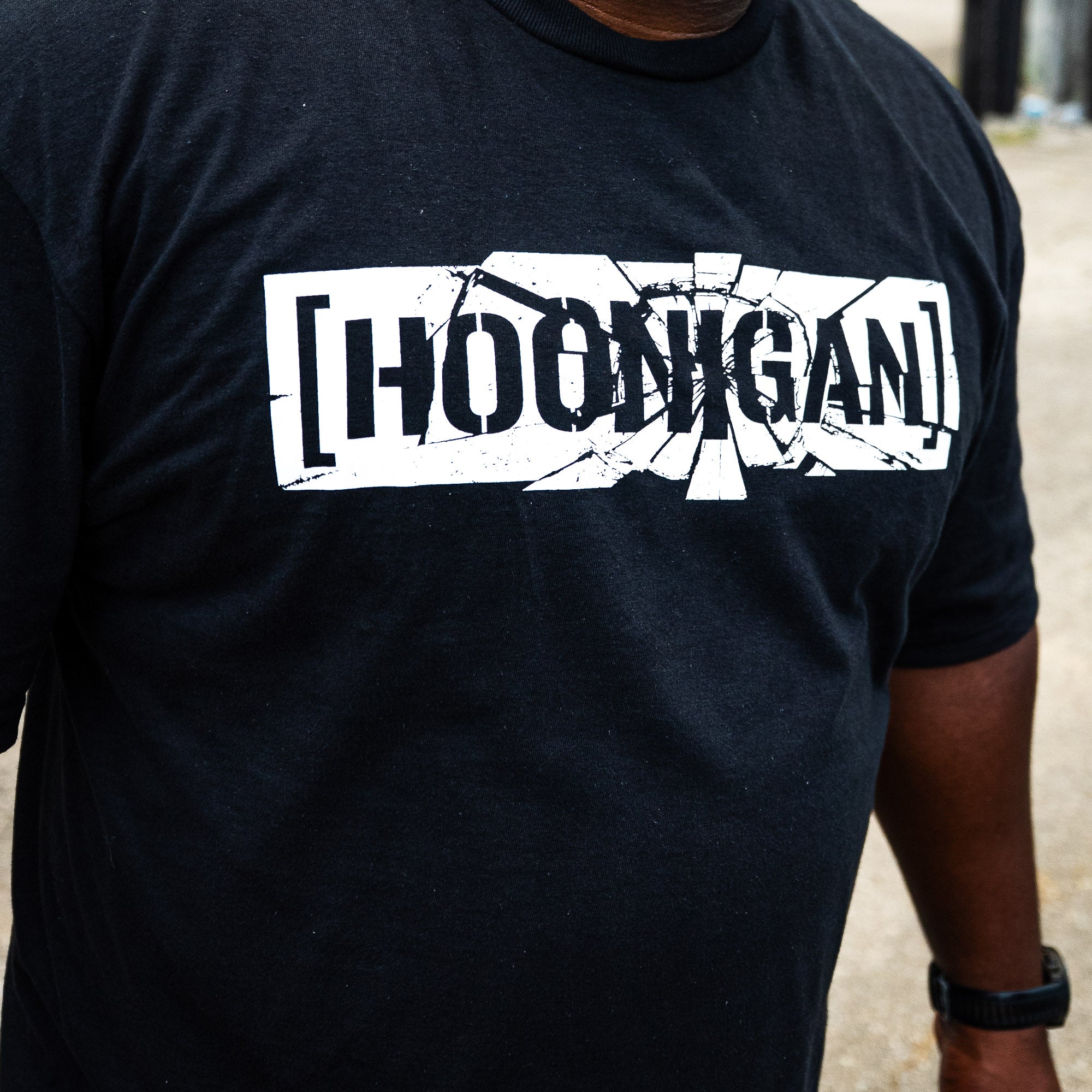 Front of the black Hoonigan SHATTERED CENSOR BAR tee with the cracked censor bar logo.