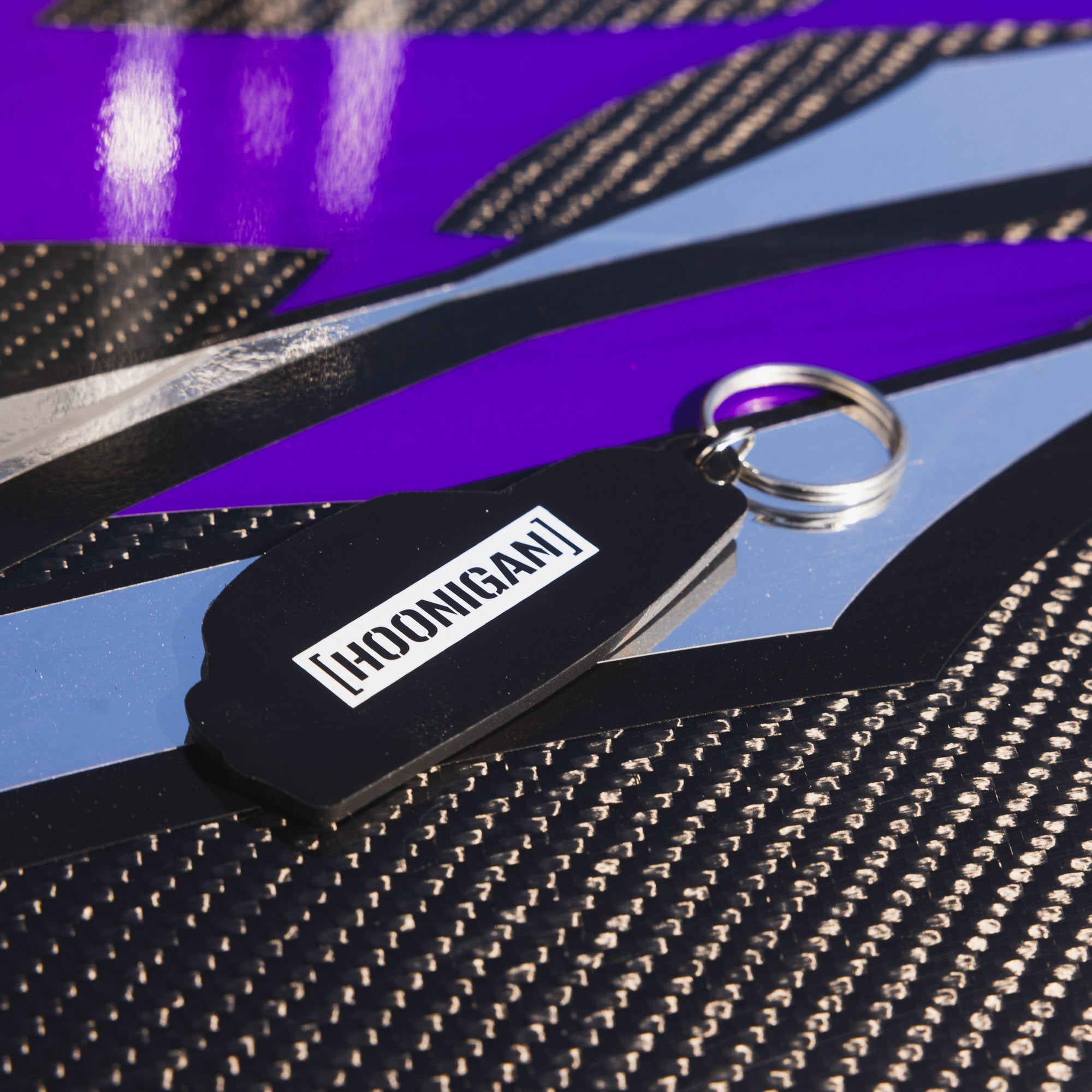 Hoonigan SD SERIES keychain with a sleek design and logo, featuring a durable metal construction.