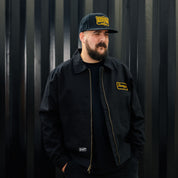 Hoonigan KNUCKLEBUSTERS Jacket in black with logo graphics on the back and sleeve, showcasing a stylish, urban design.