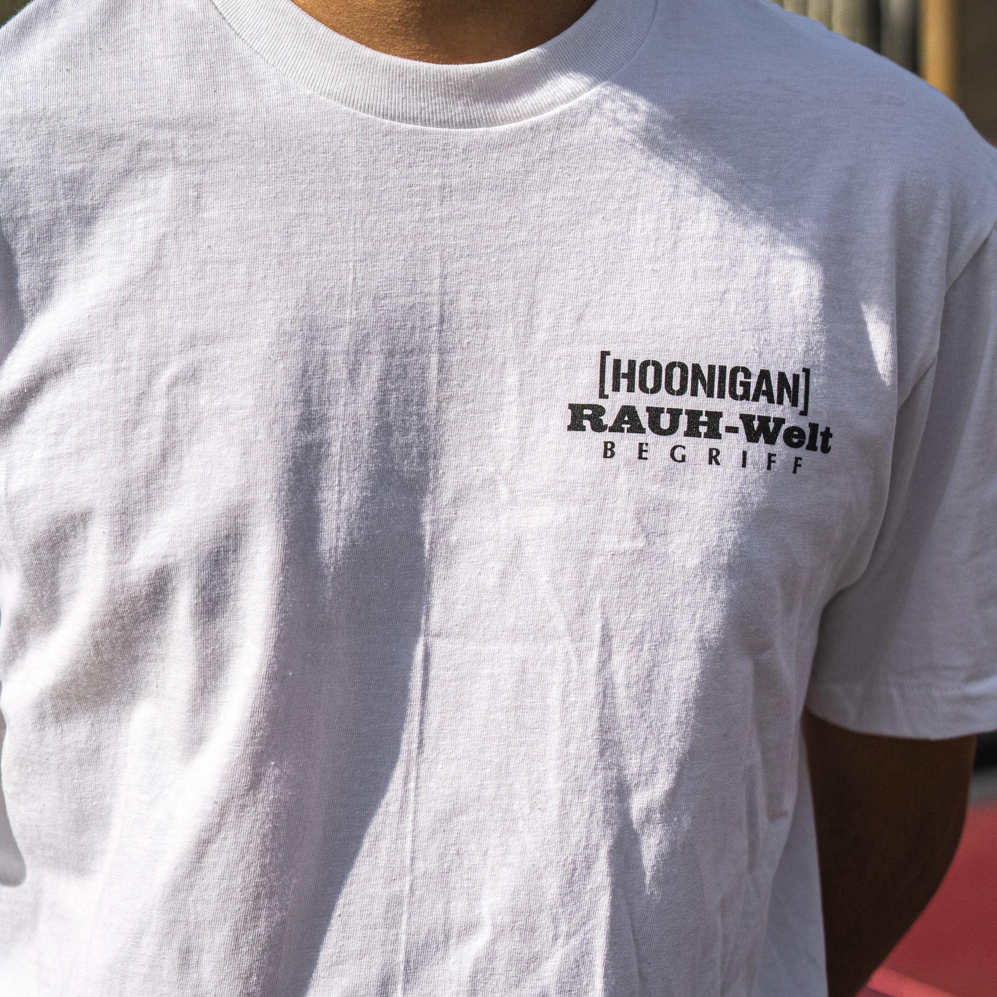 Hoonigan X RWB ROUGH WORLD KILL ALL TIRES Short Sleeve Tee featuring bold graphic design and custom logo on a black background.