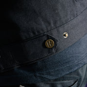 Hoonigan KNUCKLEBUSTERS Jacket in black with white logo and graphic designs, featuring a front zipper and pockets.