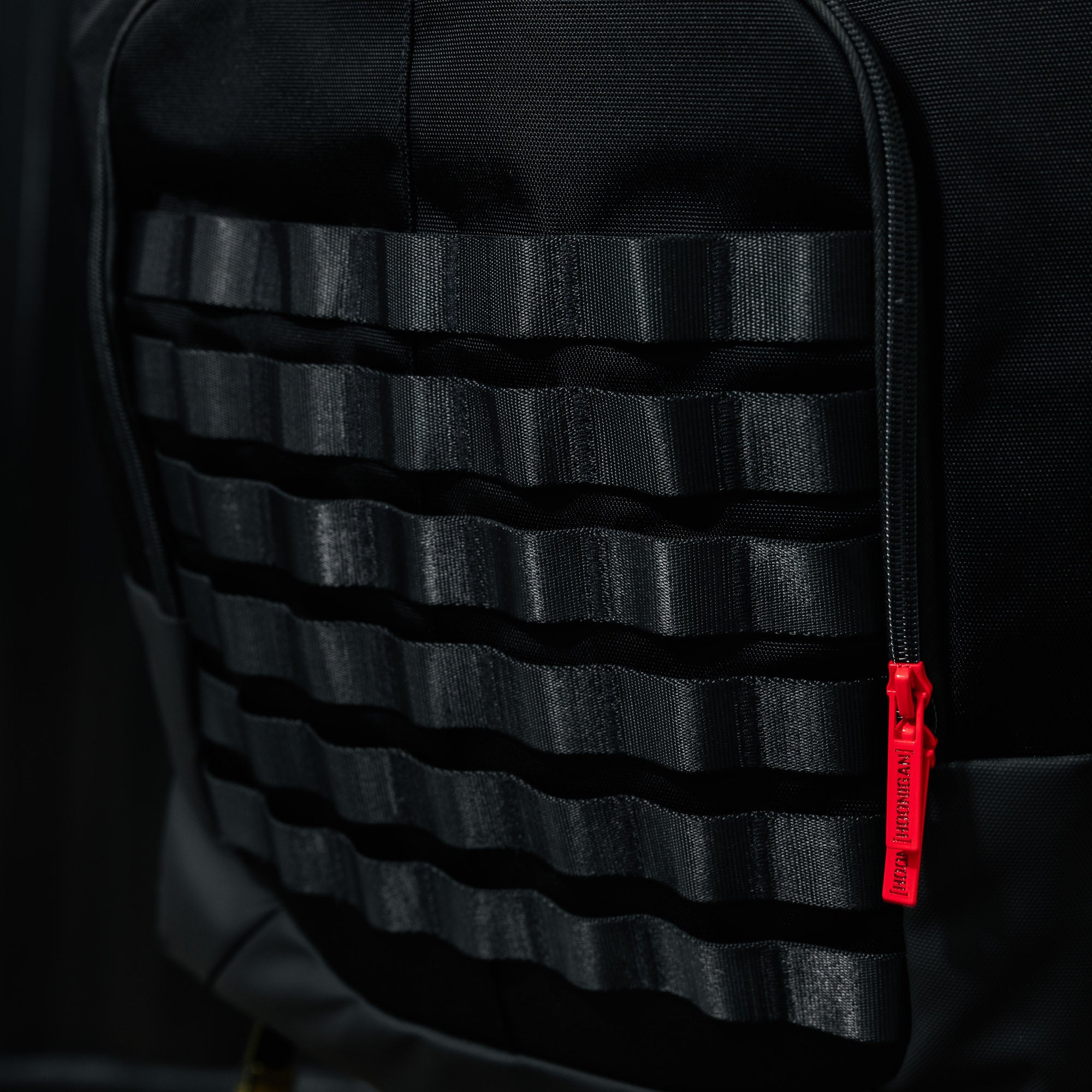 Hoonigan RATCHET STRAP Backpack featuring a durable design with adjustable straps and bold branding, ideal for outdoor activities and everyday use.