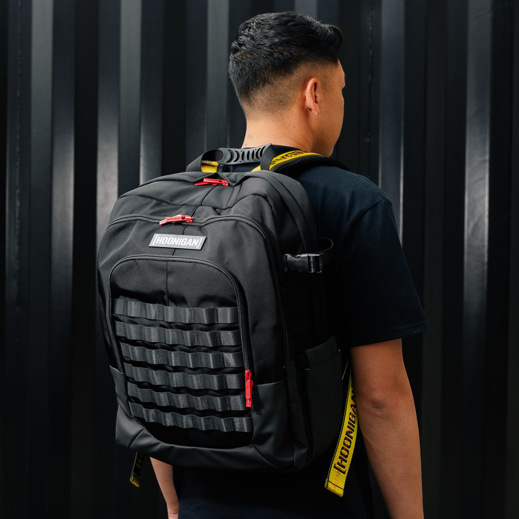 Hoonigan RATCHET STRAP Backpack featuring a durable design with adjustable straps and a bold logo, ideal for outdoor and urban use.