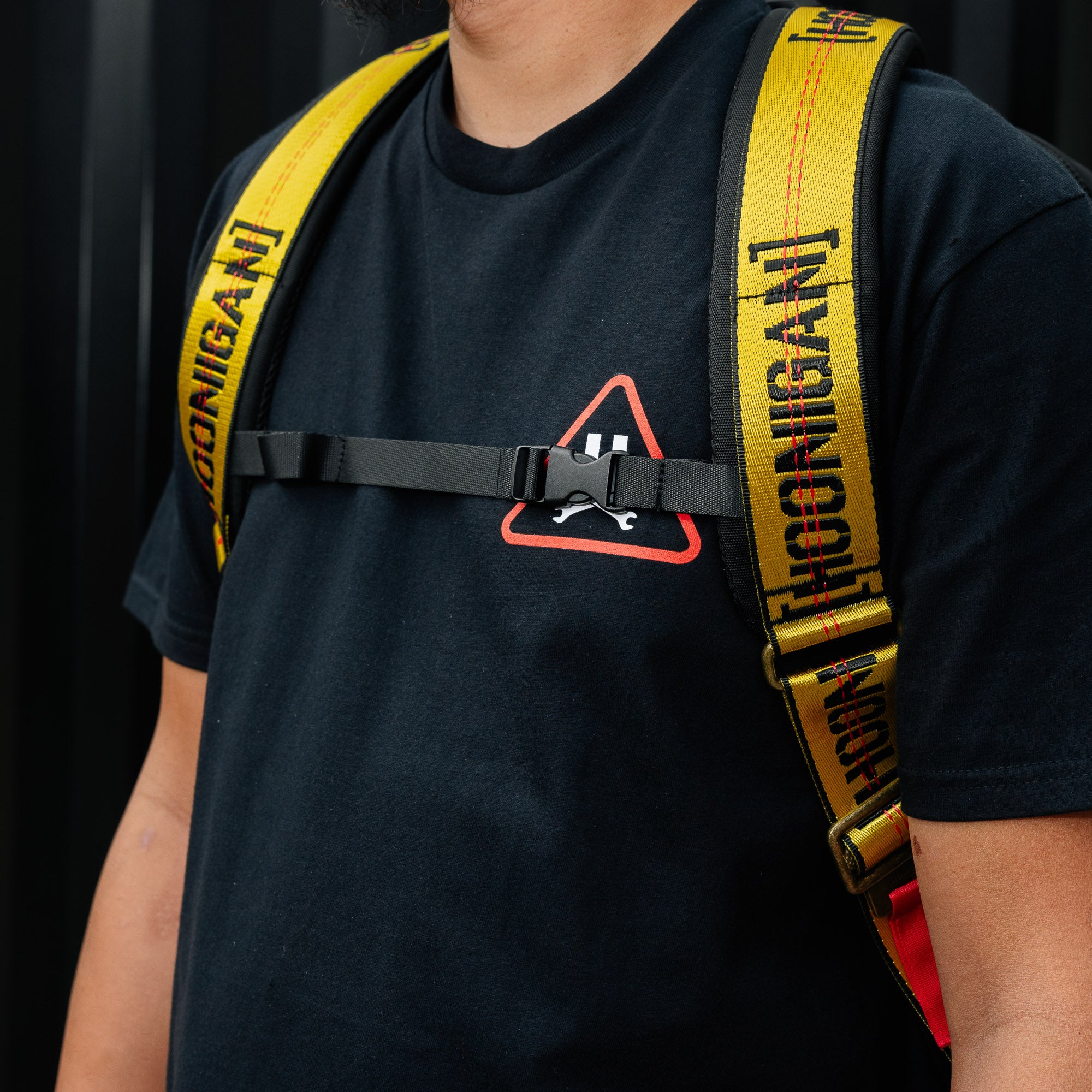 Hoonigan RATCHET STRAP Backpack featuring a vibrant design with adjustable straps and multiple compartments, ideal for outdoor activities and everyday use.
