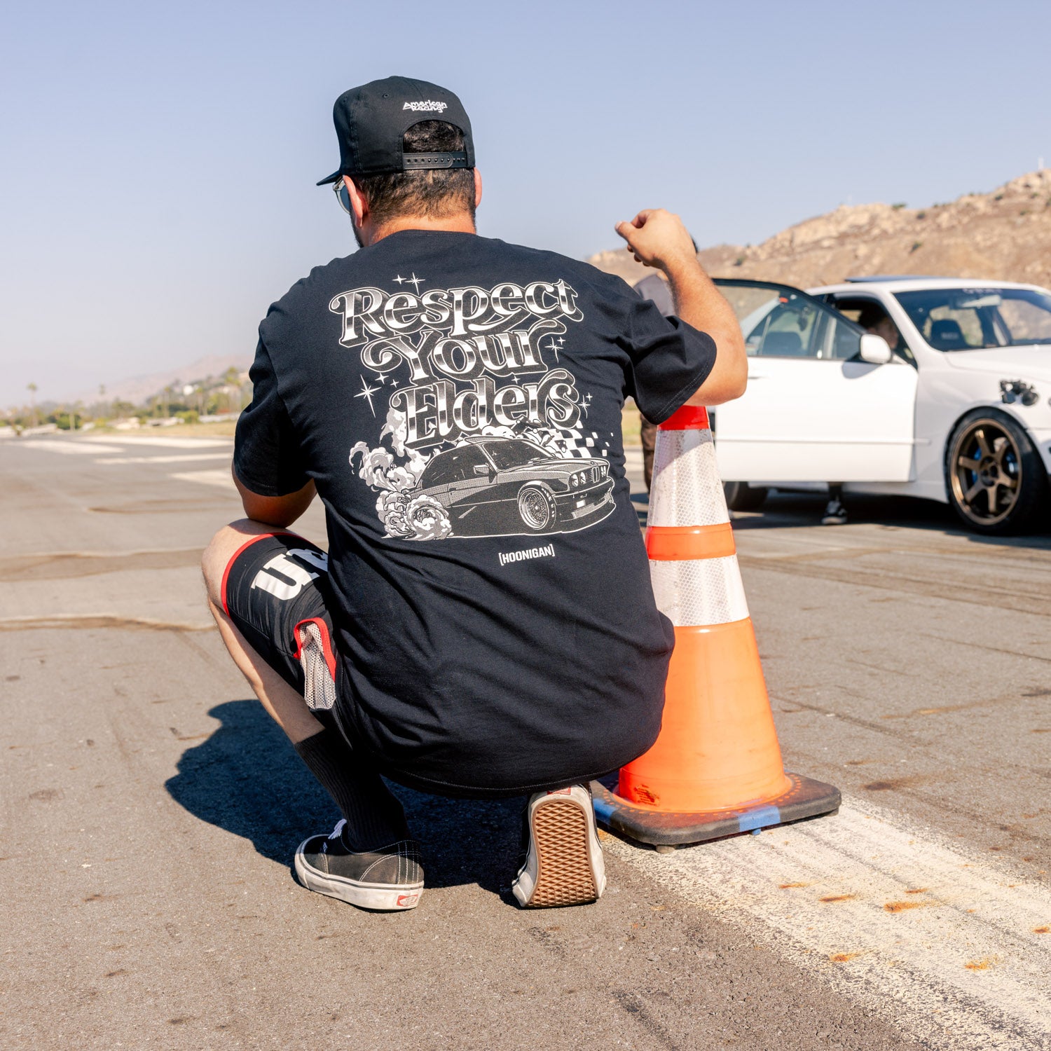 Hoonigan RESPECT YOUR ELDERS Short Sleeve Tee featuring bold black lettering on a white background, showcasing a casual and stylish design.