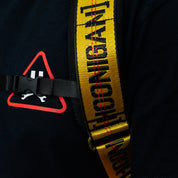 Hoonigan RATCHET STRAP Backpack featuring a durable design with adjustable straps and a bold Hoonigan logo, ideal for motorsports enthusiasts.