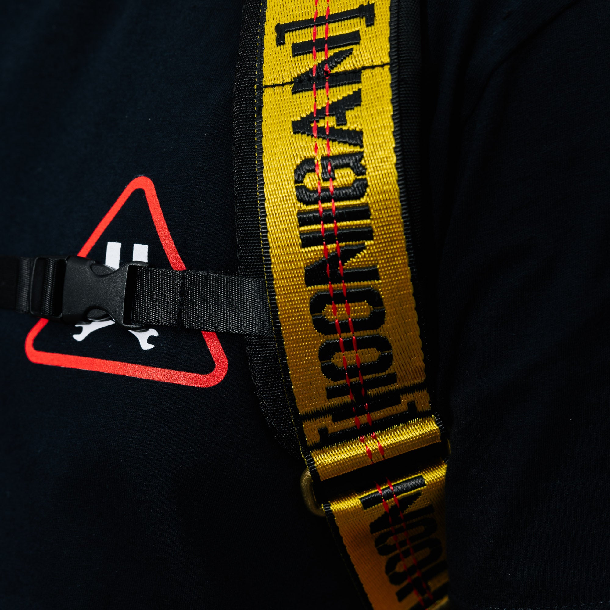 Hoonigan RATCHET STRAP Backpack featuring a durable design with adjustable straps and a bold Hoonigan logo, ideal for motorsports enthusiasts.