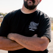 Black short sleeve tee featuring the phrase "RESPECT YOUR ELDERS" in bold white letters, overlaid with a Hoonigan logo. Ideal for motorsport enthusiasts.