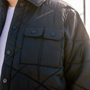 Hoonigan Motorsports VICTOR Quilted Jacket in black with white logo, featuring a stylish quilted design and zipper pockets.