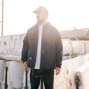 Hoonigan Motorsports VICTOR Quilted Jacket, featuring a stylish black design with quilted detailing and the Hoonigan logo on the front.