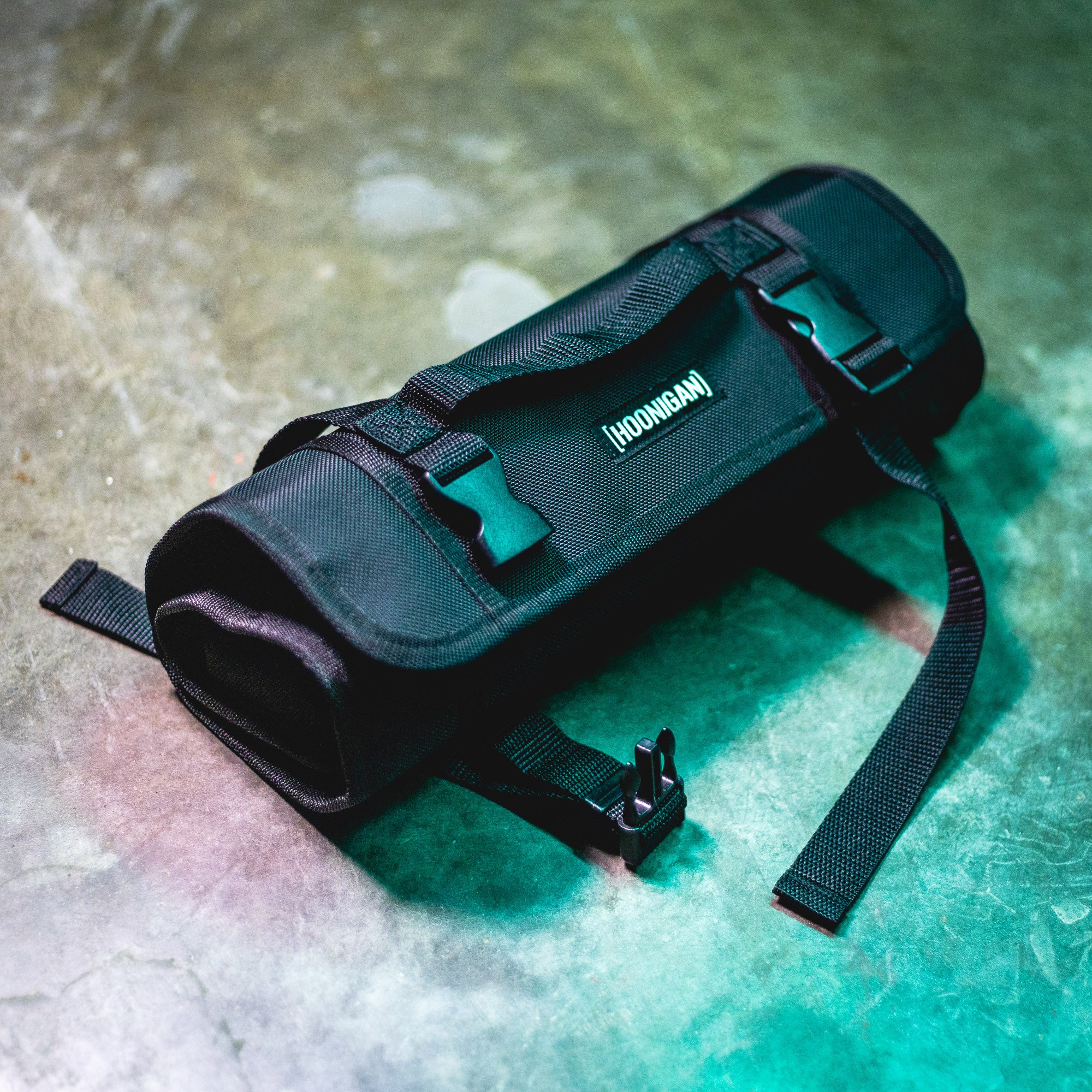 Hoonigan LIL TOOL ROLL, a compact black tool bag with adjustable straps, designed for easy storage and transport.