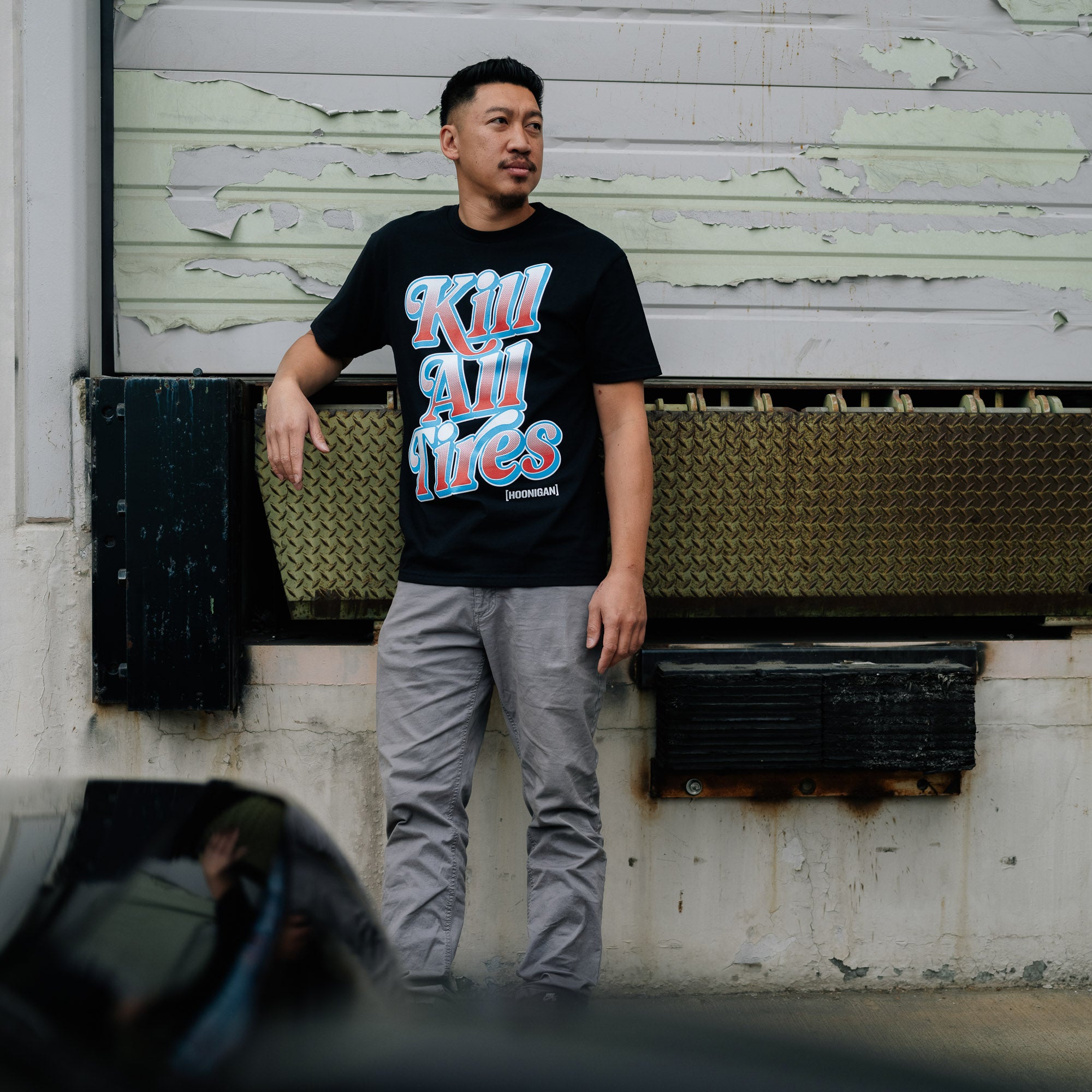 Black short sleeve tee featuring "KILL ALL TIRES V2" graphic in bold white letters, designed by Hoonigan.