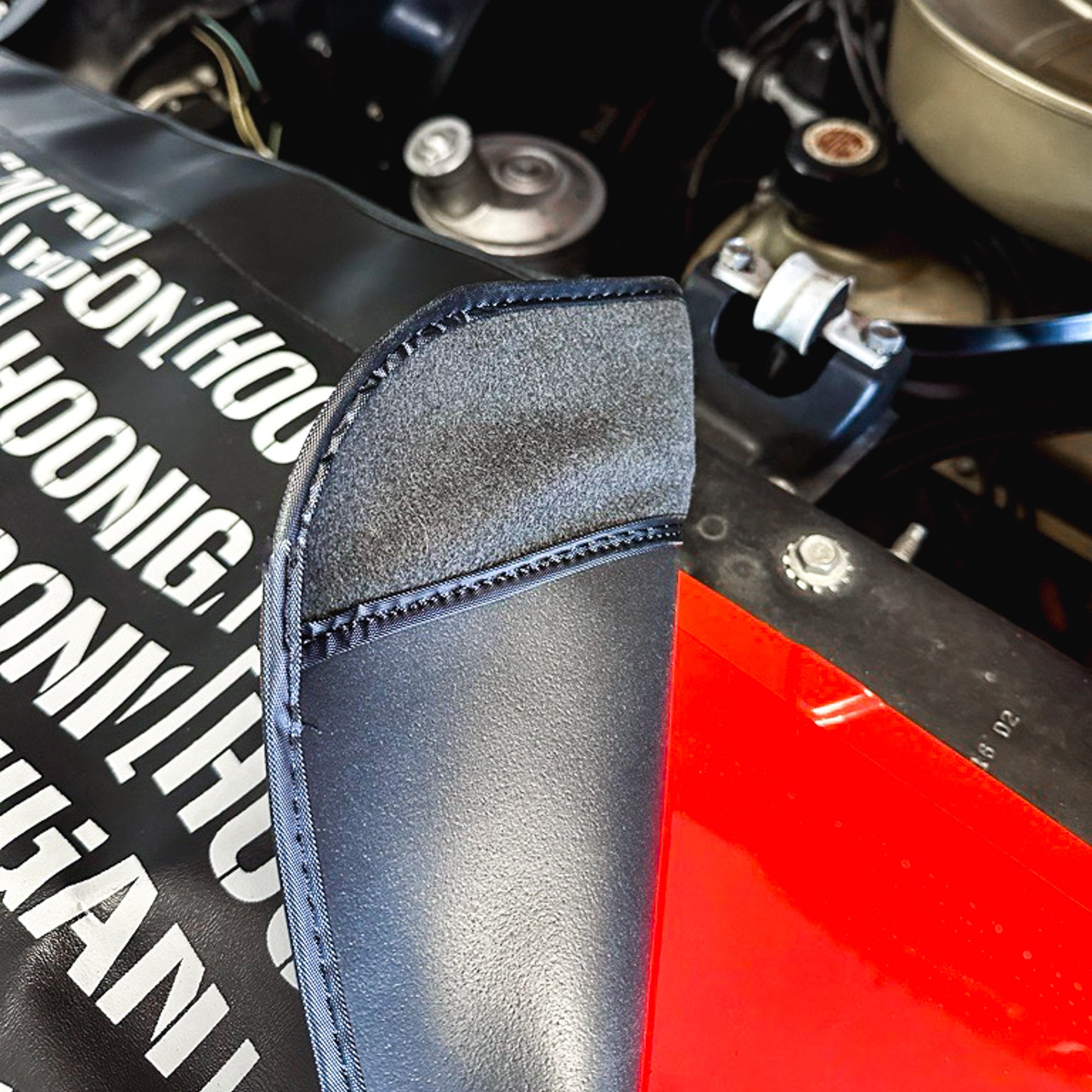 Hoonigan SCATTER PRINT Fender Cover featuring a vibrant scatter design with Hoonigan branding, designed to protect car fenders during maintenance.