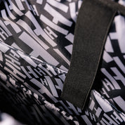 Hoonigan Ratchet Strap Backpack featuring a durable design, adjustable straps, and bold logo graphics in black and yellow.