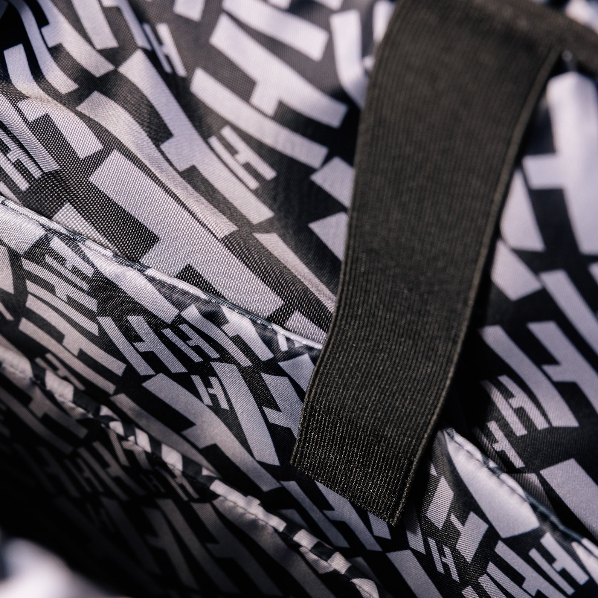 Hoonigan Ratchet Strap Backpack featuring a durable design, adjustable straps, and bold logo graphics in black and yellow.