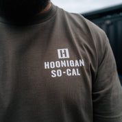 Black short sleeve Hoonigan STENCIL Tee featuring bold white "Hoonigan" logo graphic on the front.
