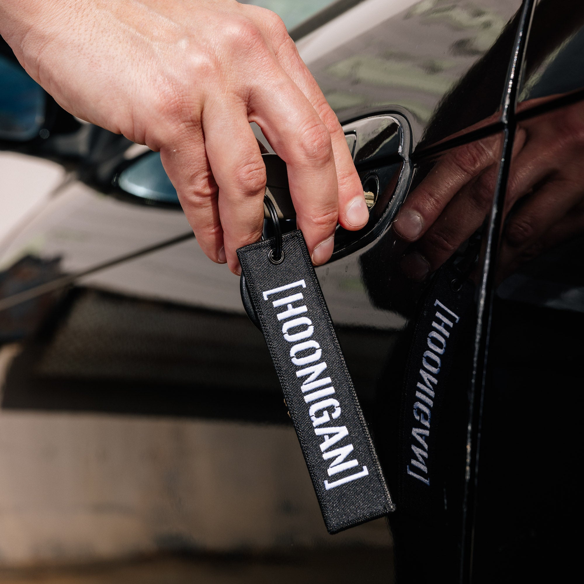 Hoonigan CENSOR BAR Jet Tag Keychain featuring a bold design with the Hoonigan logo and a vibrant color scheme.