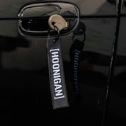 Hoonigan CENSOR BAR Jet Tag Keychain featuring a bold black and white design with the Hoonigan logo.