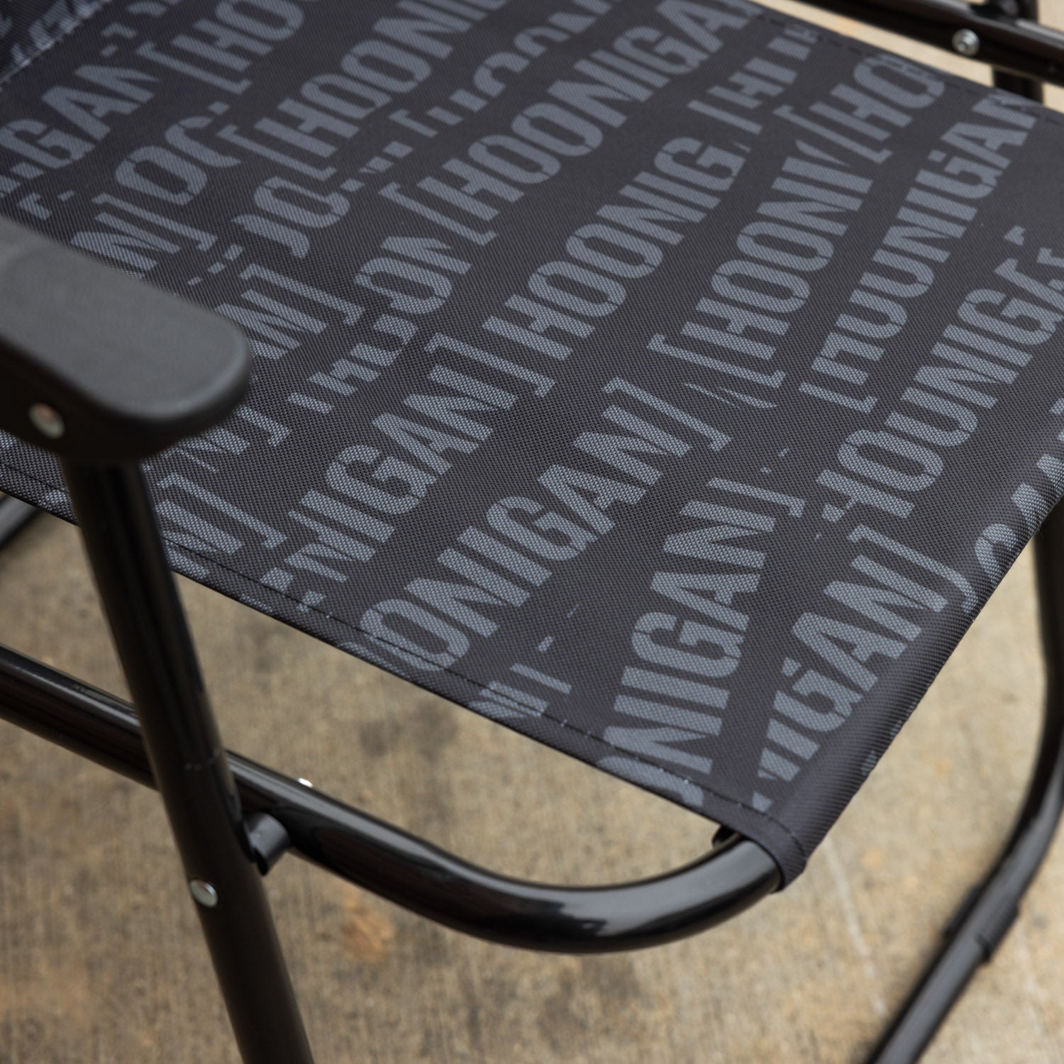 Hoonigan SCATTER CENSOR BAR collapsible chair with a black frame and vibrant graphic design, featuring a comfortable seat and backrest.