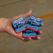 Hoonigan X Sayaka X Leen Customs Drifting Sayaka collectible pin featuring a detailed character design with vibrant colors on a sleek backing.