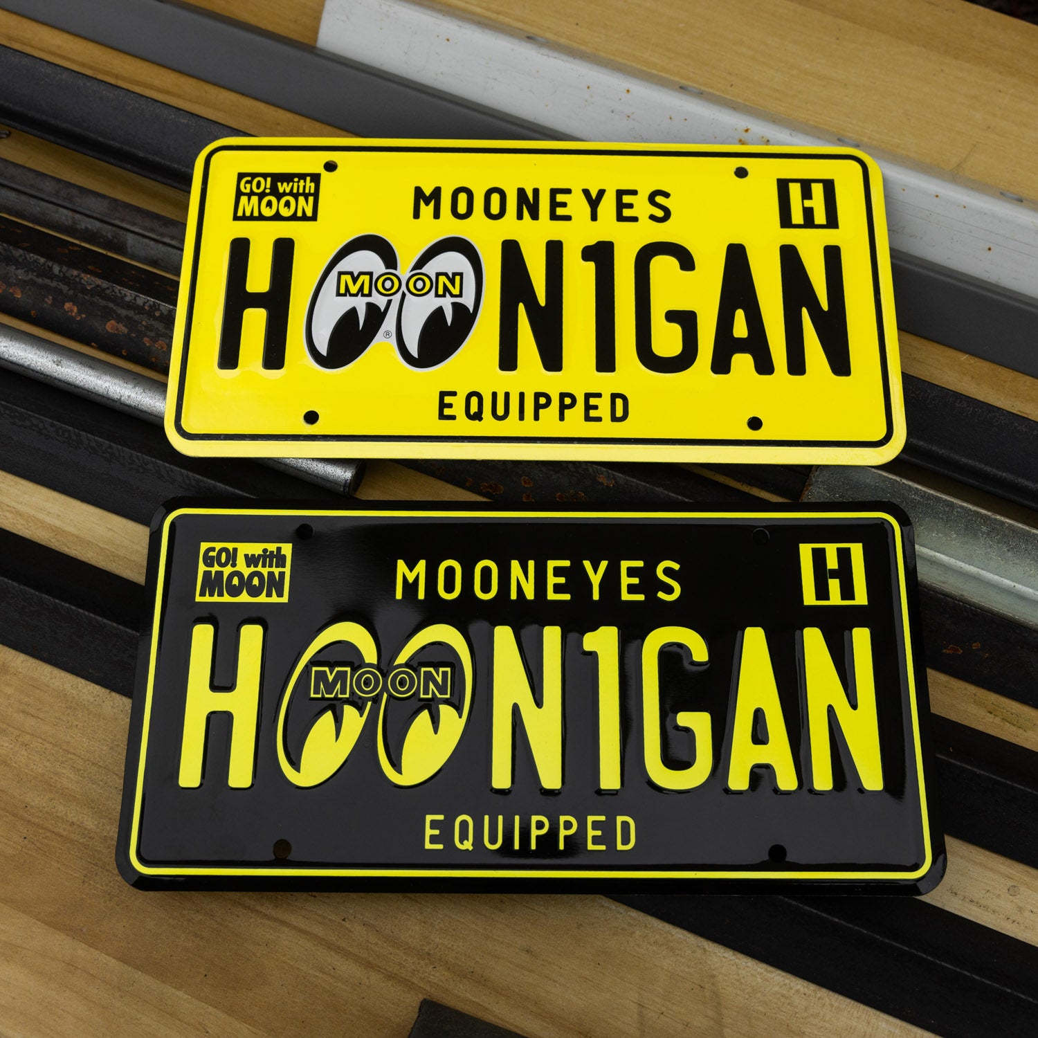Hoonigan x Mooneyes EQUIPPED license plates featuring bold graphics and vibrant colors for automotive enthusiasts.