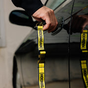 Hoonigan RATCHET STRAP lanyard featuring a durable design with a bold Hoonigan logo, perfect for securing items and easy carrying.