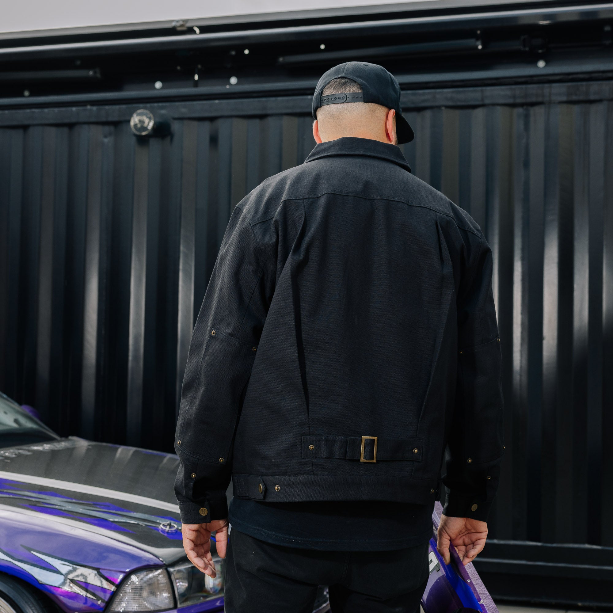 Hoonigan KNUCKLEBUSTERS black jacket with logo on chest and graphic design on the back.