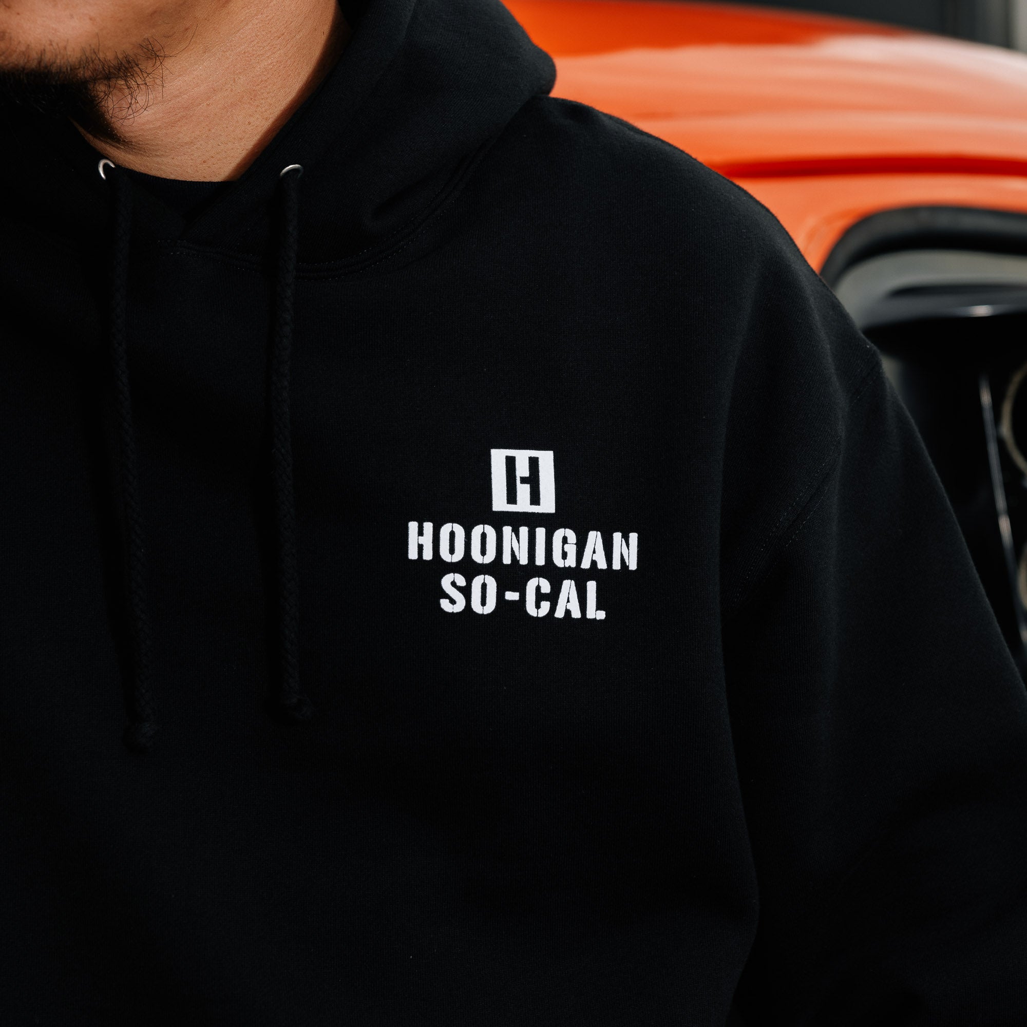 Hoonigan STENCIL Pullover Hoodie featuring a bold graphic design in black and white on a dark gray background.