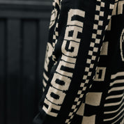 Hoonigan TIRE SLAYER Ugly Xmas Pullover featuring a festive design with car graphics and holiday motifs.