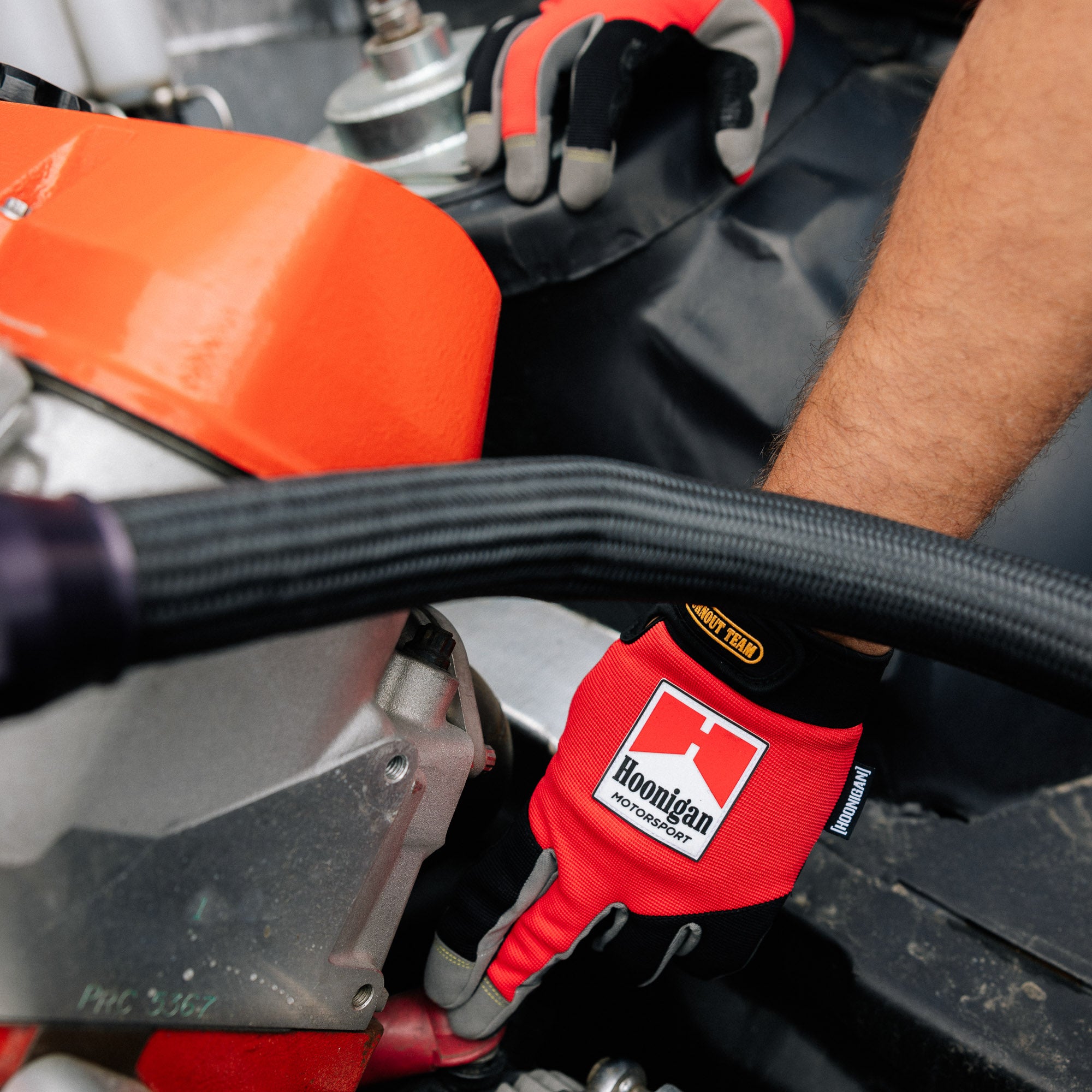 Hoonigan Surgeon General gloves featuring a black design with white graphics and the Hoonigan logo.