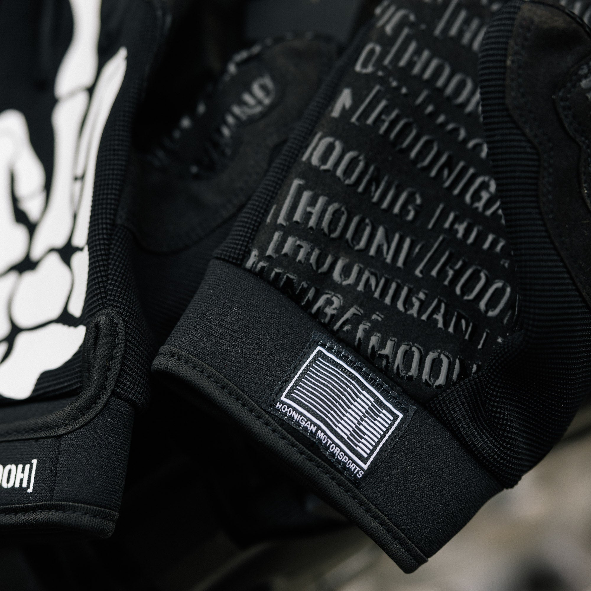 Hoonigan FIND OUT Gloves featuring a black and yellow design with the Hoonigan logo, designed for motorsport activities.