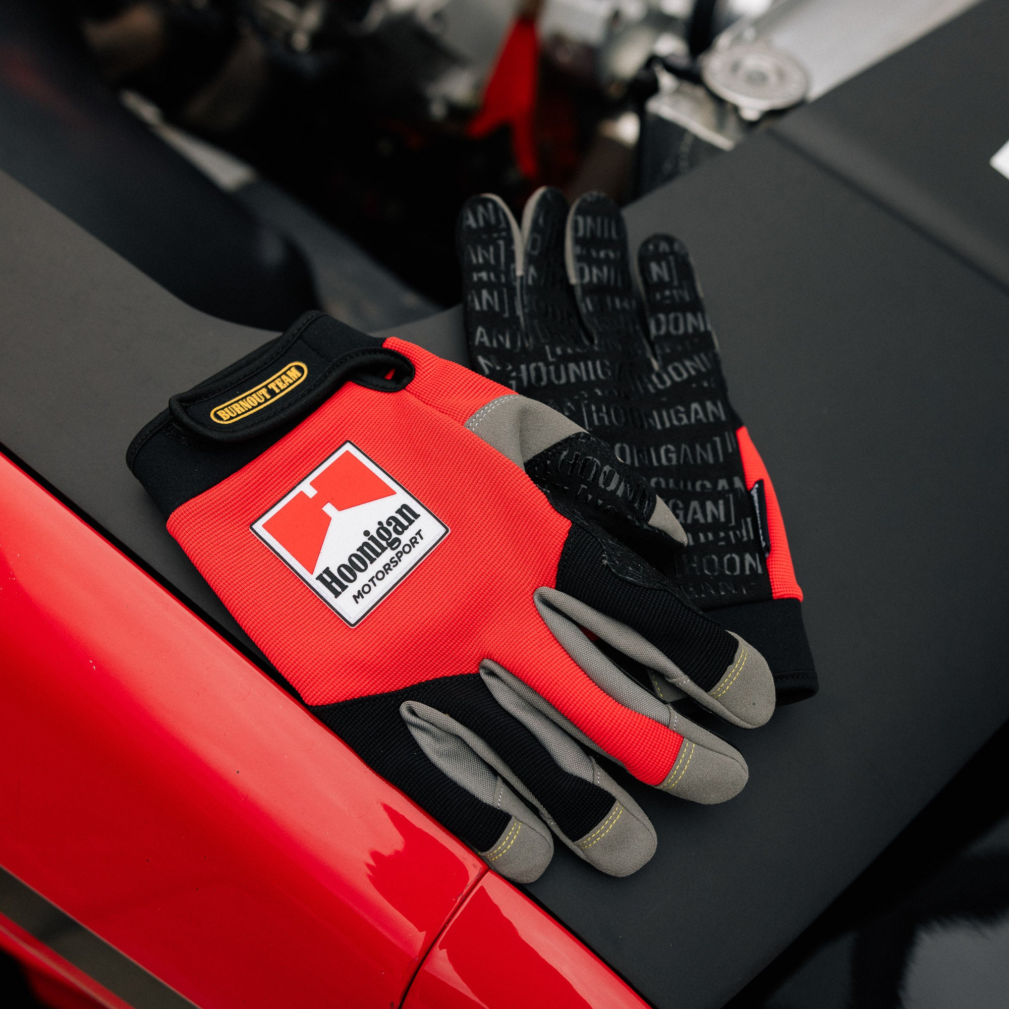 Hoonigan Surgeon General gloves featuring black fabric with white logo and design accents.