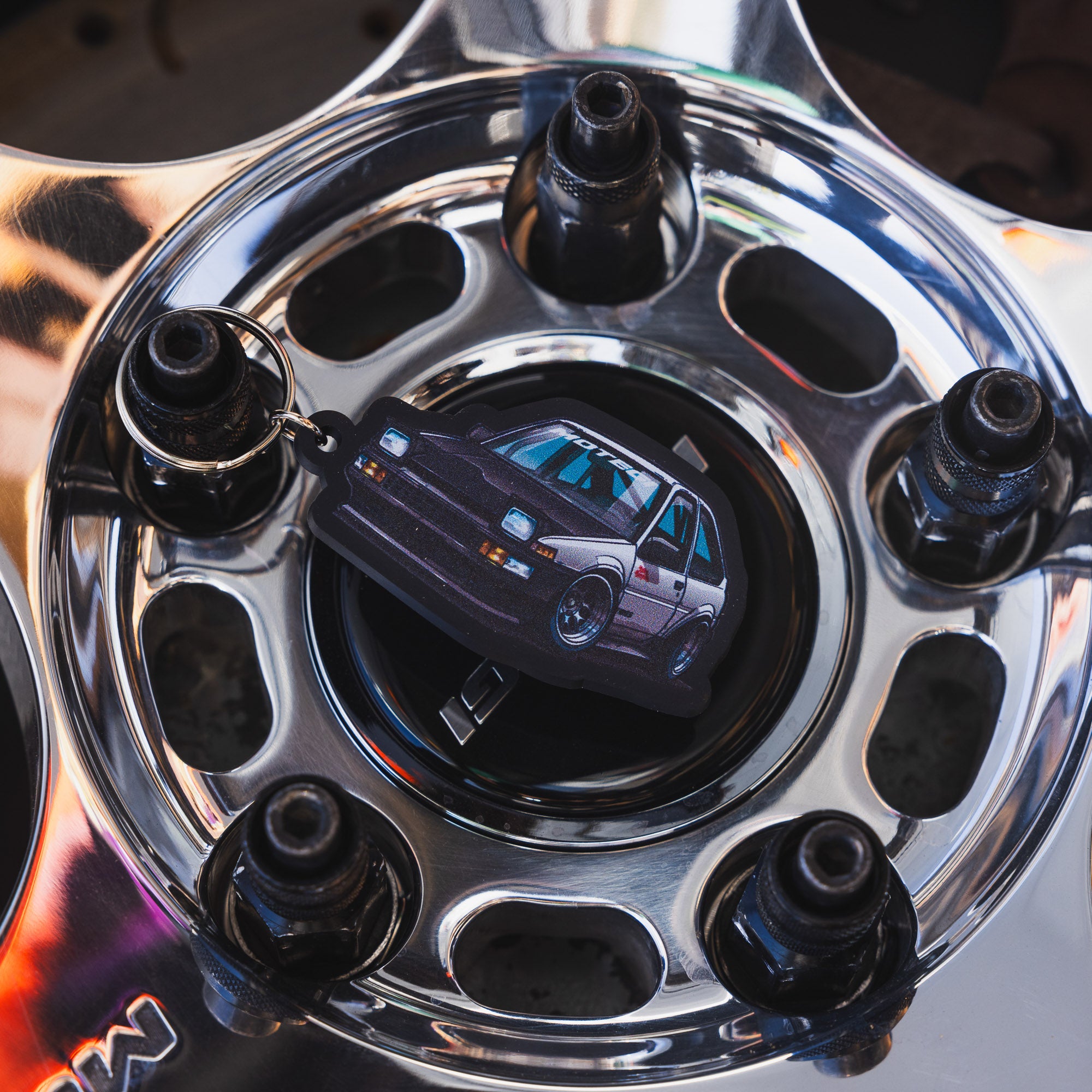 Motegi SD Series metal keychain featuring a sleek design with the Motegi logo and a matte finish.