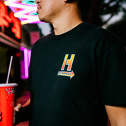 Hoonigan HOONCAPACITOR Short Sleeve Tee in black featuring a colorful graphic design of a capacitor with the Hoonigan logo.