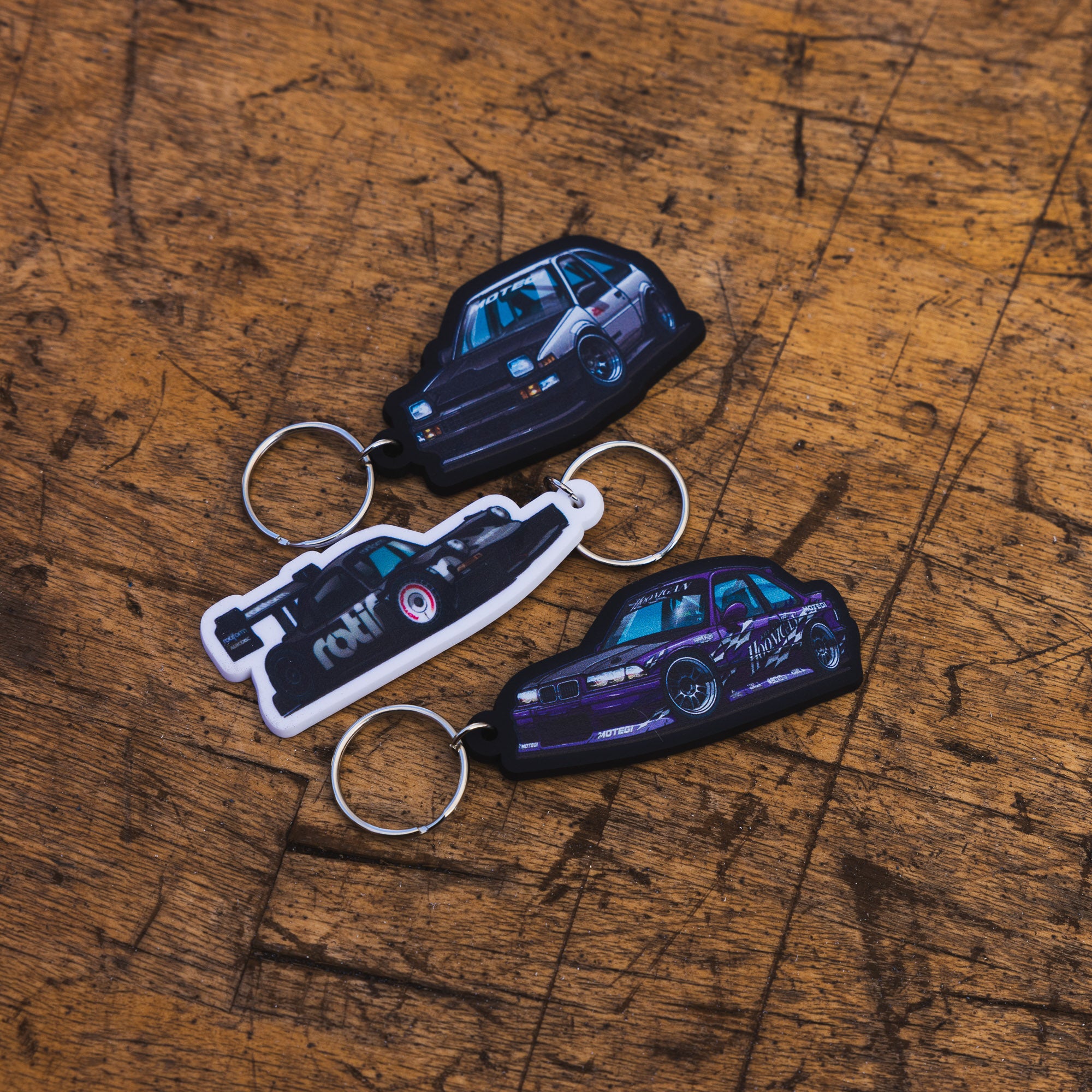 Motegi SD Series keychain featuring a black and silver design with the Motegi logo.