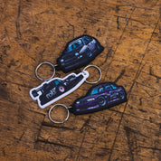 Hoonigan SD Series keychain featuring a black and white design with the Hoonigan logo and tire tread pattern.